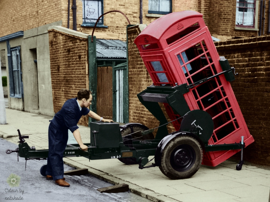 A worker installs a K6 phone box, London late 1930s.